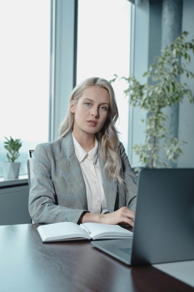 pexels-photo-5717546-5717546 Portrait of a confident businesswoman working on her laptop in a modern office setting.