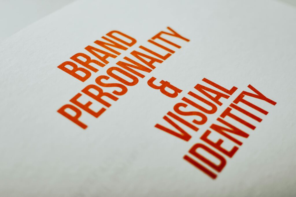 pexels-photo-7661492-7661492 Close-up of 'Brand Personality & Visual Identity' text in red on white paper.